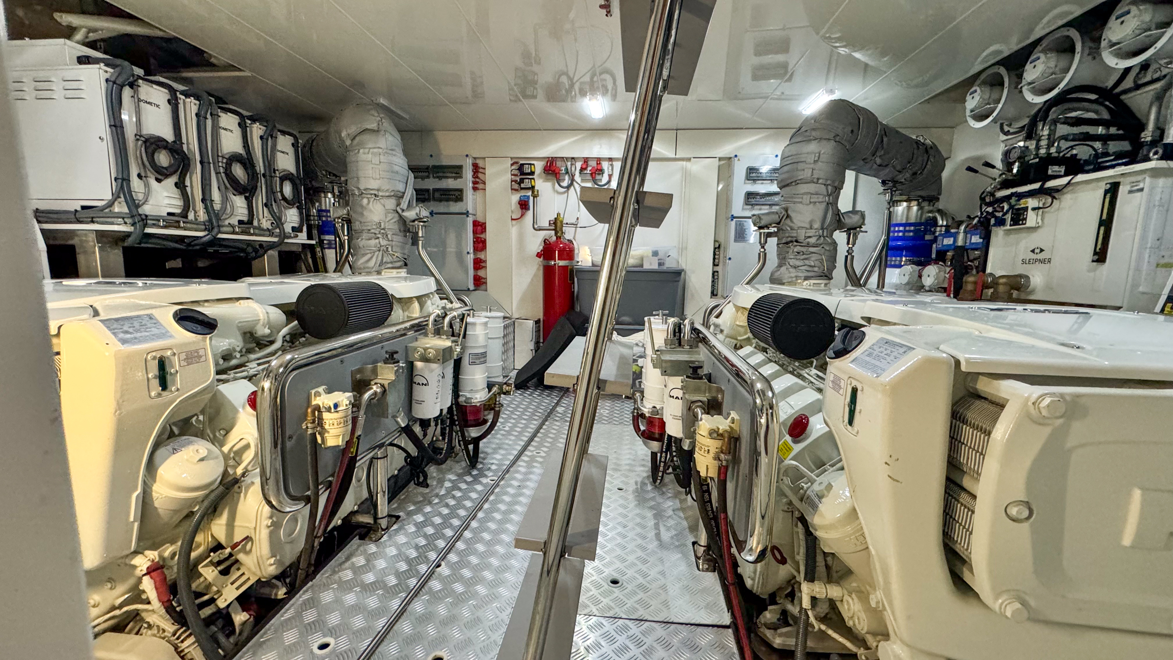 Twin diesel engine room — clean operational bay aboard a South Florida motor yacht