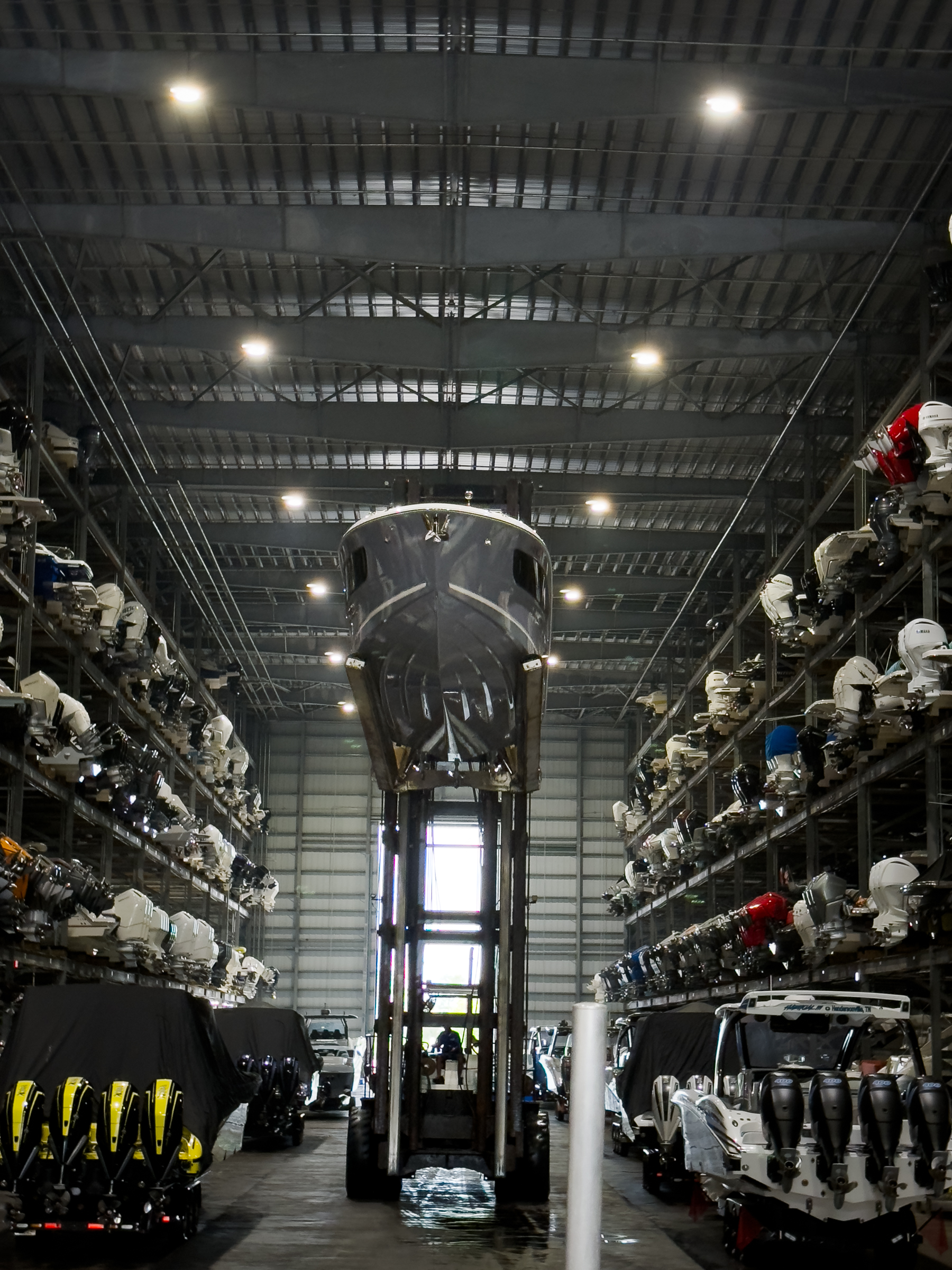 Center console vessel suspended in dry-storage warehouse, South Florida
